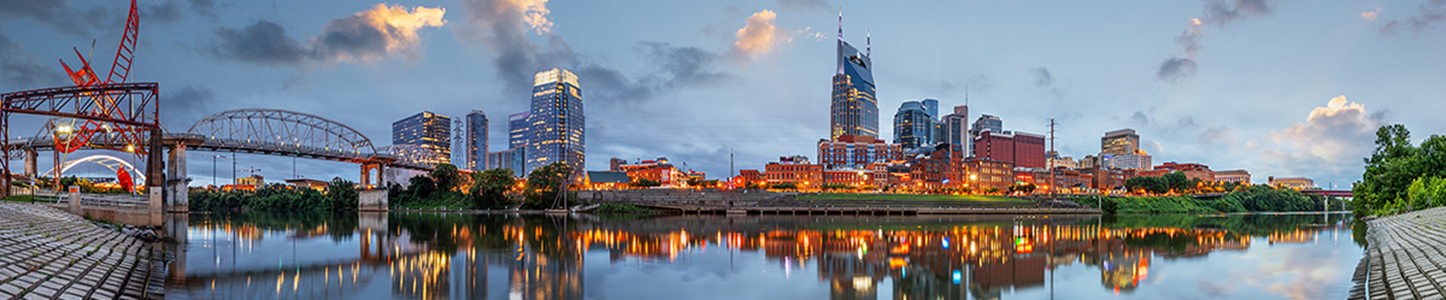 Nashville, Tenessee, USA downtown city skyline on the Cumberland River at twilight.